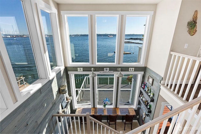 living room featuring a healthy amount of sunlight, hardwood / wood-style flooring, and a water view