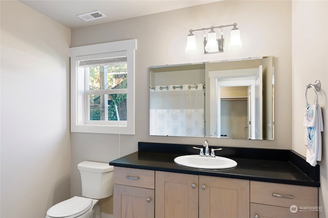 bathroom with vanity and toilet