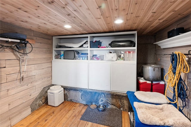 interior space with wooden ceiling, wood walls, and light hardwood / wood-style flooring