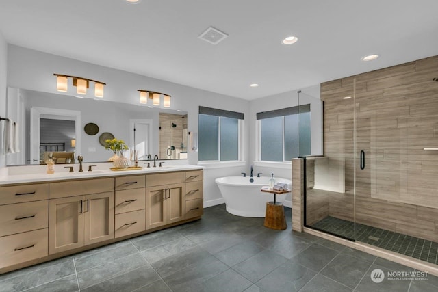 bathroom with tile patterned floors, vanity, and shower with separate bathtub