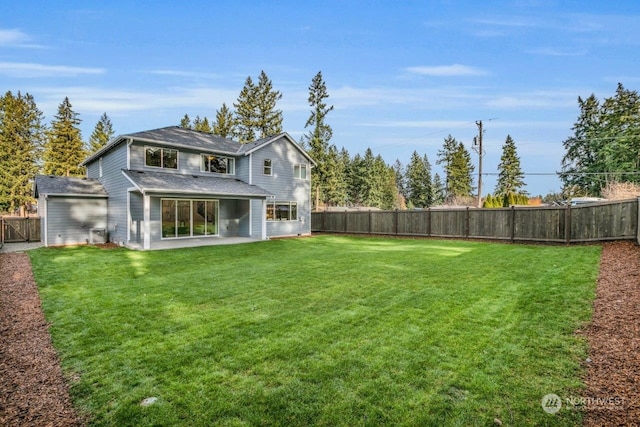 rear view of house featuring a patio and a lawn