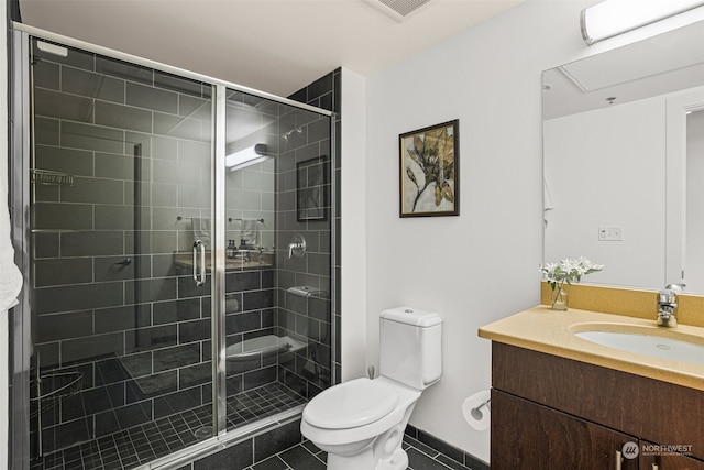 full bath featuring toilet, tile patterned flooring, a shower stall, and vanity