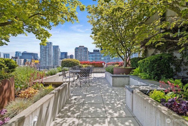 view of patio featuring a view of city and outdoor dining space