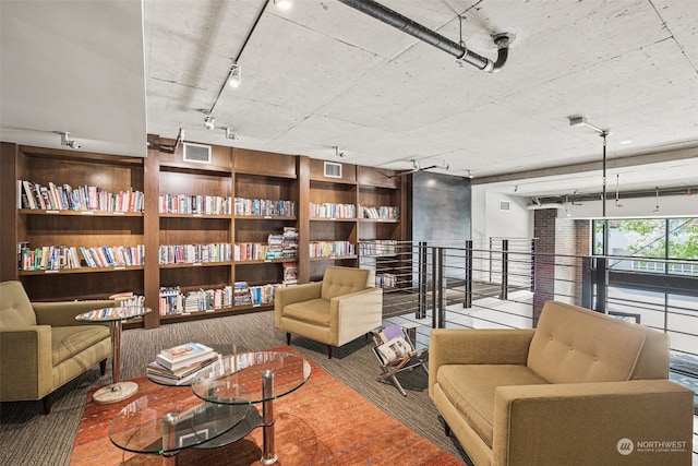 living area with rail lighting and visible vents