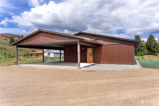 view of front of property featuring a carport