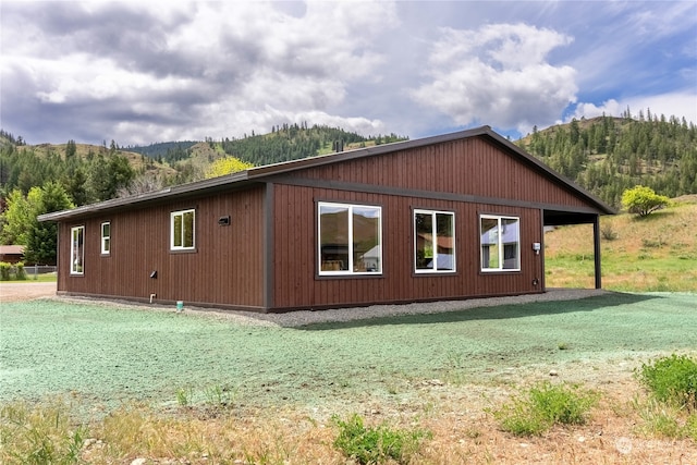 view of property exterior with a mountain view