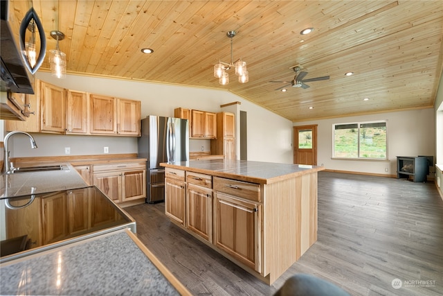 kitchen featuring sink, hardwood / wood-style floors, decorative light fixtures, and wood ceiling