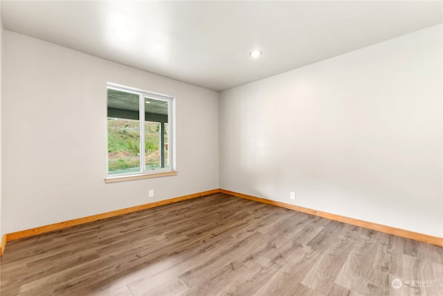 spare room featuring light hardwood / wood-style flooring