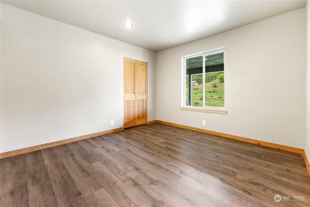 spare room with hardwood / wood-style flooring