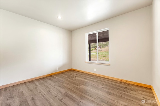 spare room with hardwood / wood-style flooring