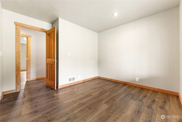 unfurnished room with dark hardwood / wood-style floors