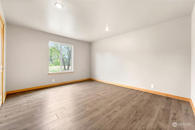 spare room with hardwood / wood-style flooring