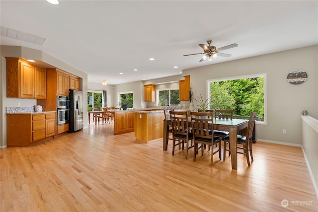 dining room with light hardwood / wood-style flooring and ceiling fan