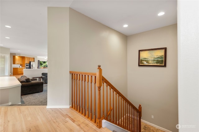 stairs featuring wood-type flooring