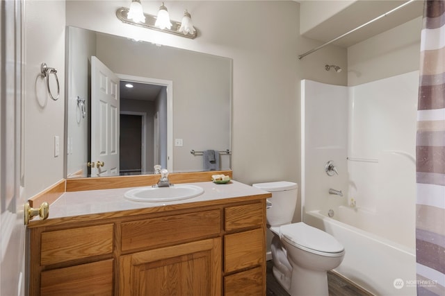 full bathroom featuring shower / bath combination with curtain, vanity, and toilet