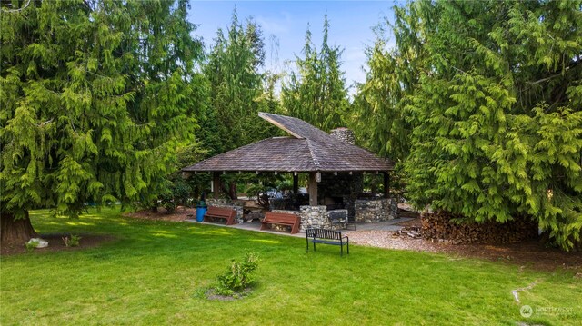 view of yard with a gazebo, a patio area, and exterior bar