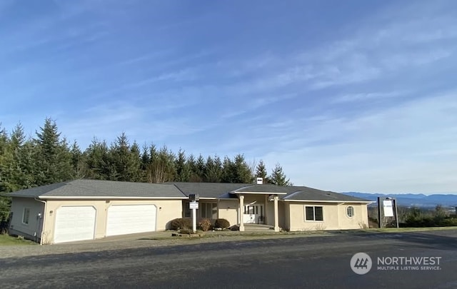 view of front facade with a garage and a mountain view