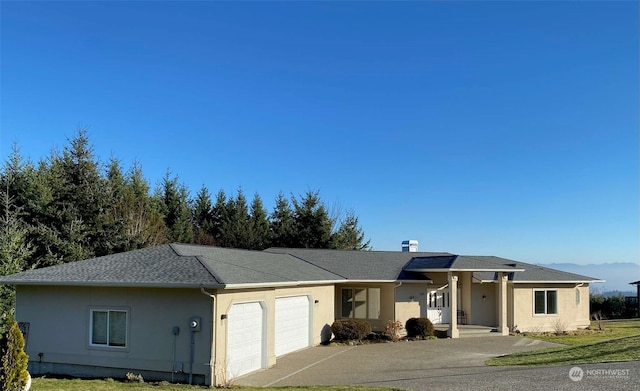 view of front facade with a garage and a front lawn