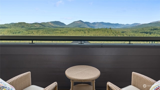 view of patio / terrace with a balcony and a mountain view