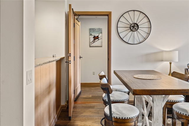 dining space featuring dark hardwood / wood-style flooring