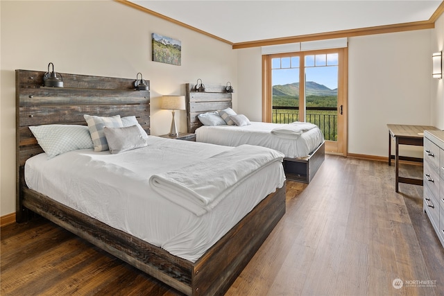 bedroom featuring hardwood / wood-style flooring, ornamental molding, and access to exterior