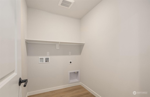 laundry room with hookup for a washing machine, light hardwood / wood-style flooring, and electric dryer hookup