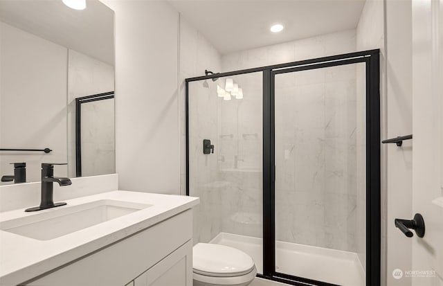 bathroom featuring vanity, toilet, and walk in shower