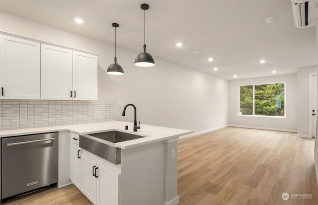 kitchen with dishwasher, backsplash, white cabinets, decorative light fixtures, and kitchen peninsula