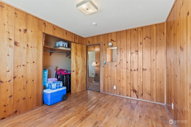 513 Cleveland Ave, South Cle Elum, WA 98943 - unfurnished bedroom featuring a closet, light wood-type flooring, and wood walls