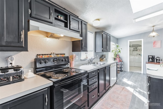 kitchen with extractor fan, dishwasher, washing machine and dryer, electric range, and sink