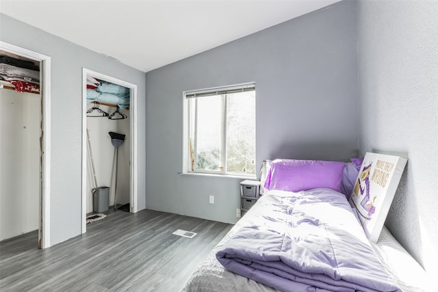 bedroom with dark hardwood / wood-style flooring