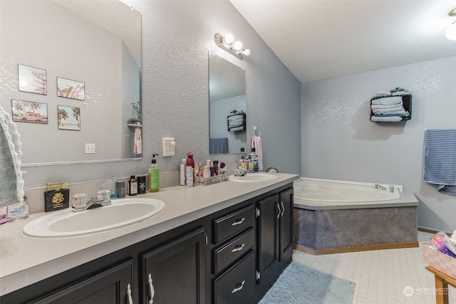 bathroom with vanity with extensive cabinet space, dual sinks, a bath, and tile floors