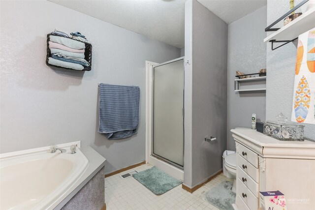 bathroom with tile flooring, shower with separate bathtub, a textured ceiling, and toilet