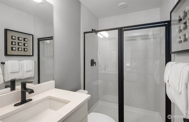 bathroom with an enclosed shower, toilet, and vanity