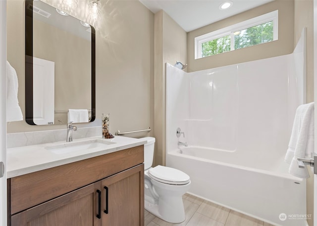 full bathroom featuring tile flooring, large vanity, toilet, and tub / shower combination