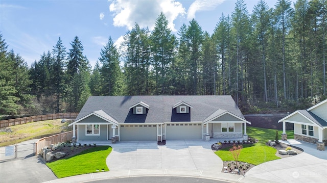 view of front of house featuring a garage and a front lawn