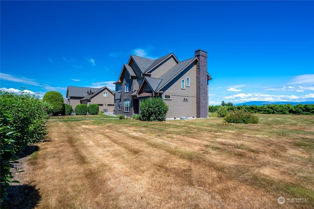 view of property exterior with a lawn