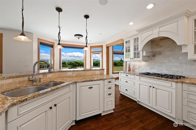 kitchen with a wealth of natural light, sink, and decorative light fixtures