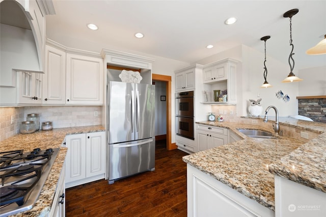 kitchen featuring stainless steel appliances, sink, and backsplash