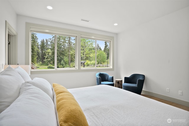 bedroom with hardwood / wood-style flooring