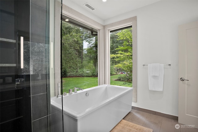 bathroom featuring shower with separate bathtub