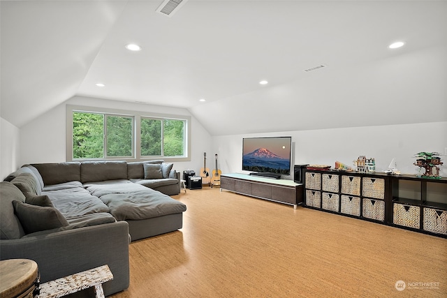 living room featuring vaulted ceiling and light hardwood / wood-style floors