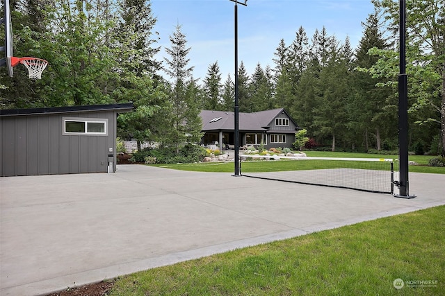 view of basketball court with a lawn