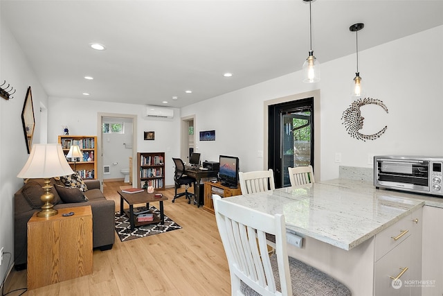 interior space featuring light hardwood / wood-style floors and an AC wall unit