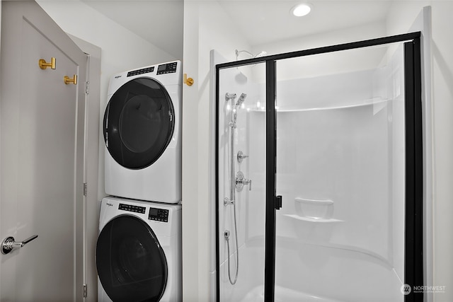 washroom with stacked washing maching and dryer