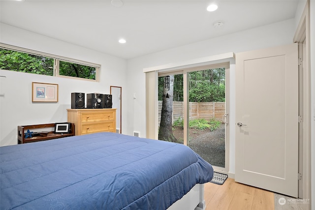 bedroom with access to exterior and light hardwood / wood-style floors