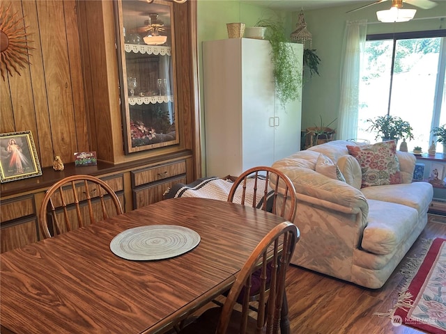 dining area with dark hardwood / wood-style floors and ceiling fan