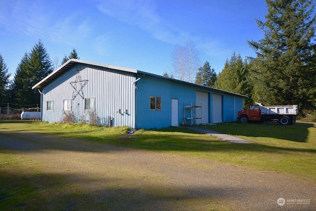 view of outbuilding with a garage and a yard