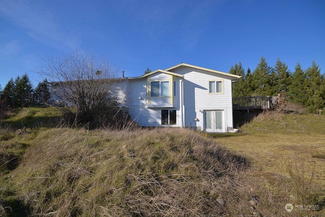 rear view of property with a deck and french doors