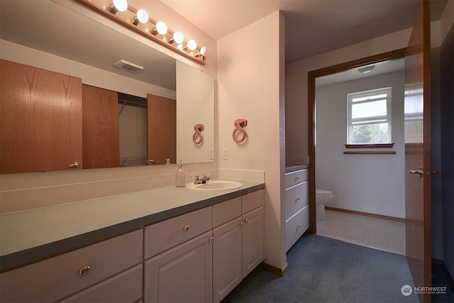 bathroom with vanity and toilet